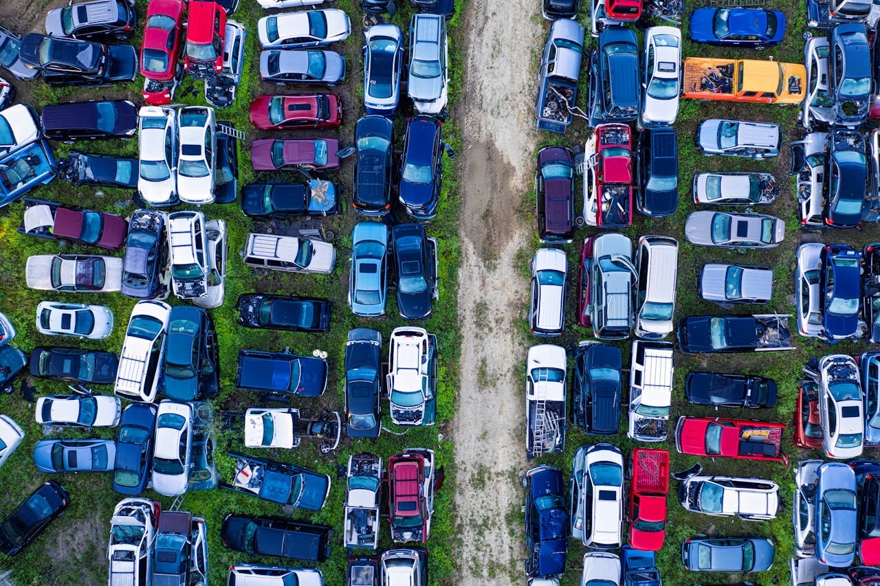 heros-img Aerial view of a car junkyard in Red Wing, MN, showcasing rows of parked vehicles.